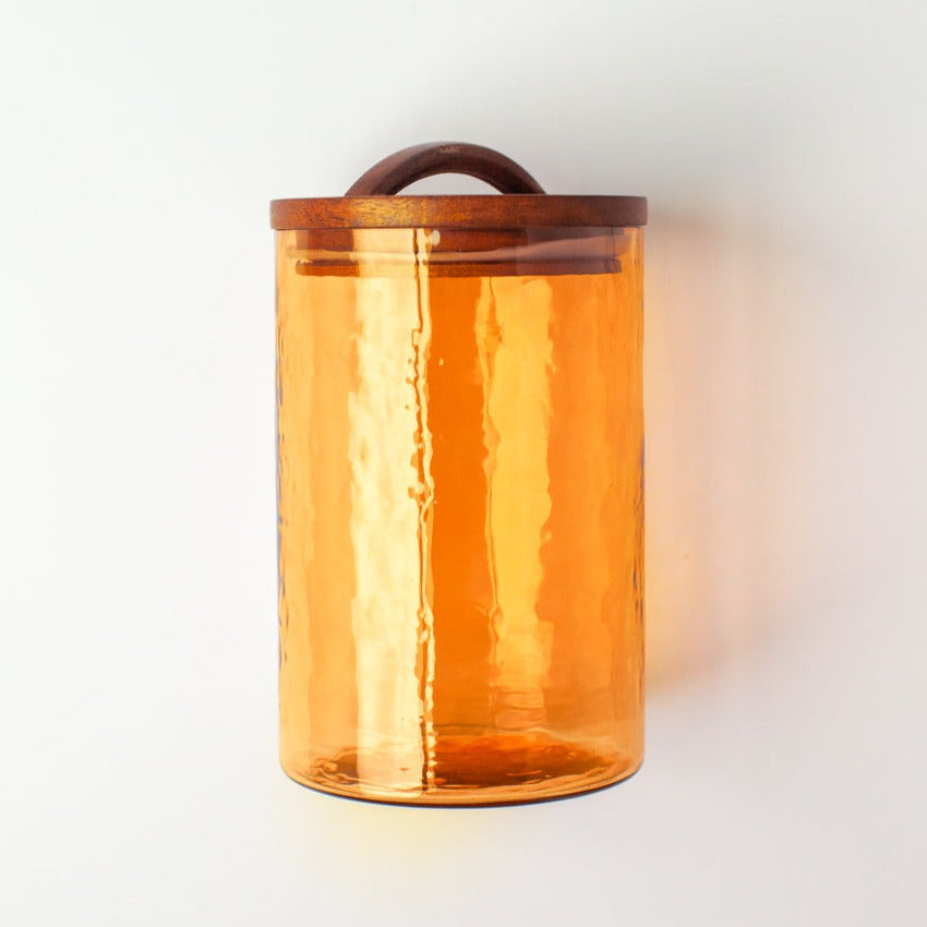 Handblown glass canister in the color of amber. Wooden lids are hand carved.