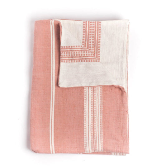 Reversible, handmade cotton baby blanket in the color of blush pink.